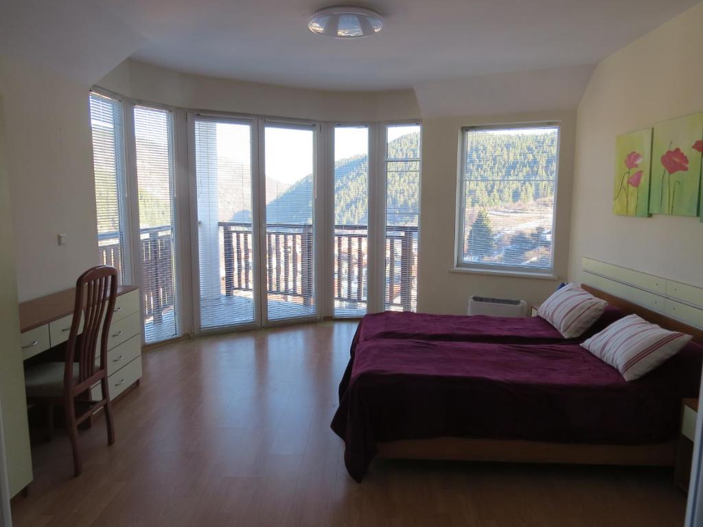 Panoramic 301 - Bright master bedroom with floor-to-ceiling windows and mountain view