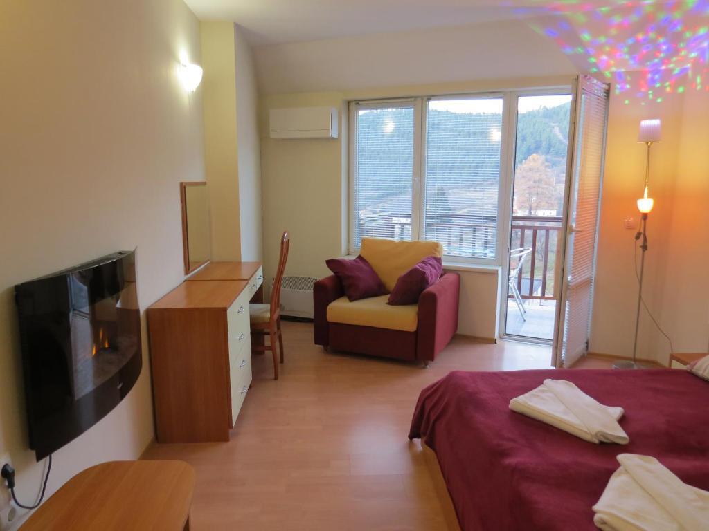 Panoramic 301 - Luxury master bedroom with fireplace, armchair and panoramic forest view